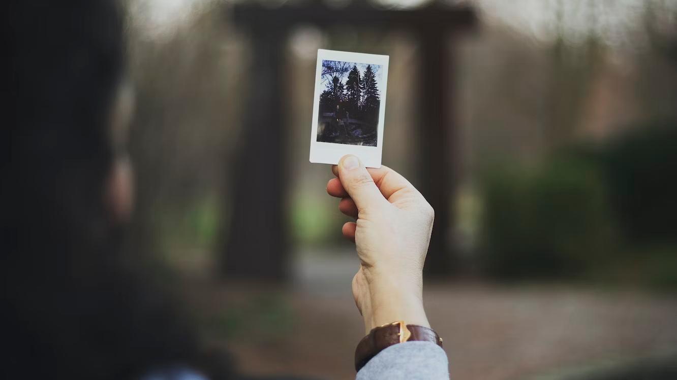 Hand holding a poloroid photograph